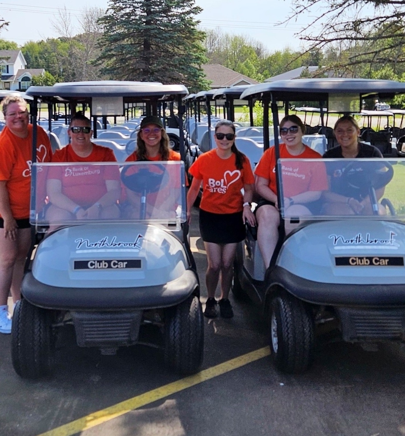 Group of volunteers sitting on golf carts